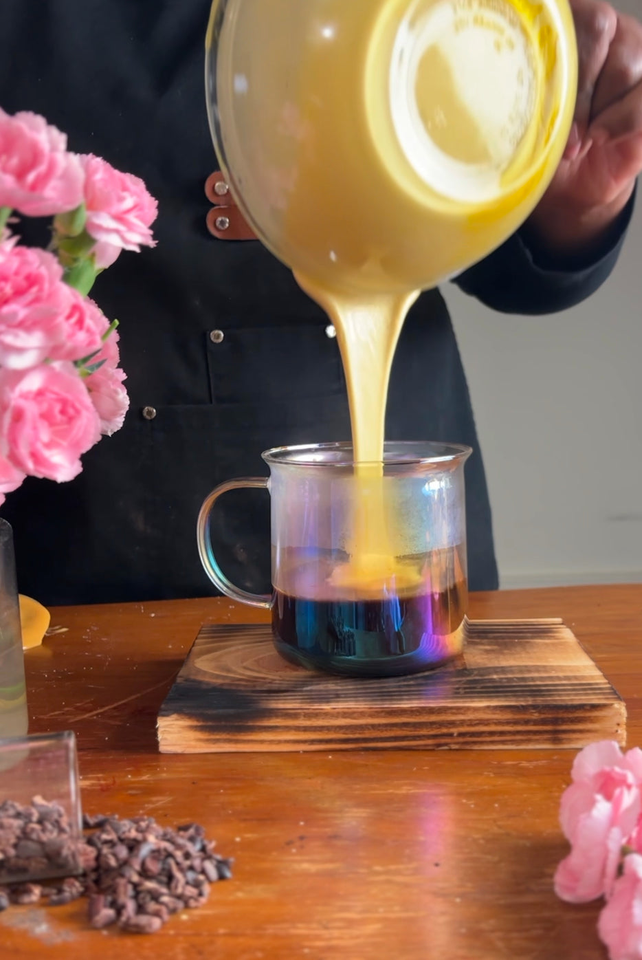 Chef Saidah Farrell of Joy Craft Cocoa pours egg mixture into hot cocoa as part of her hot chocolate eggspresso recipe.